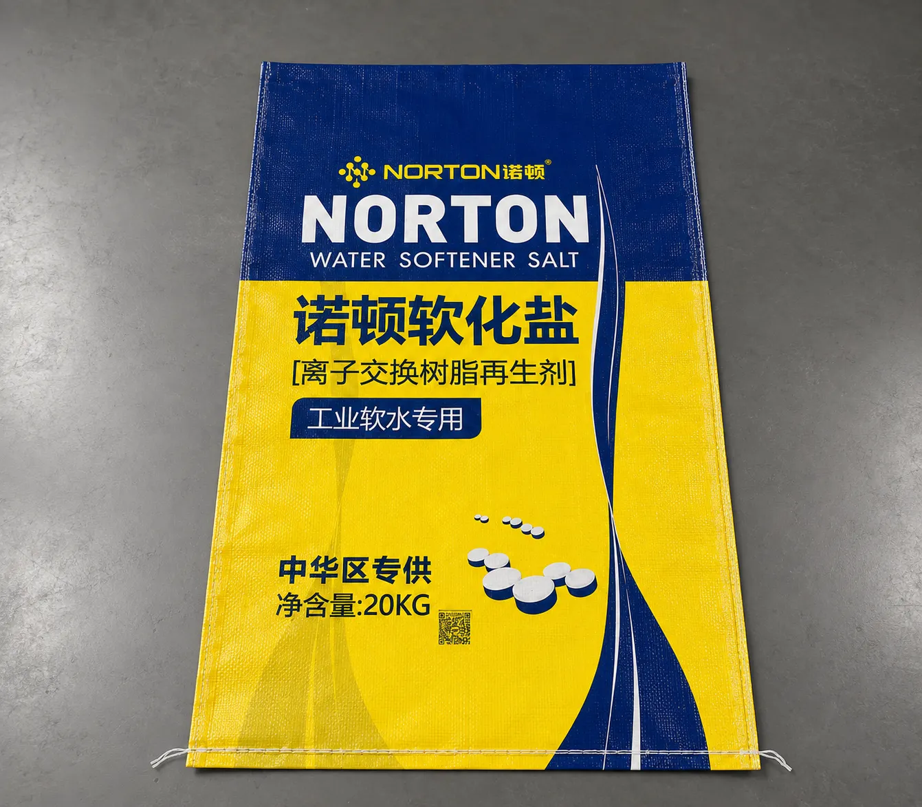 A blue and yellow bag for water-soluble industrial salt; detail of the high-contrast branding and moisture-sensitive product panel